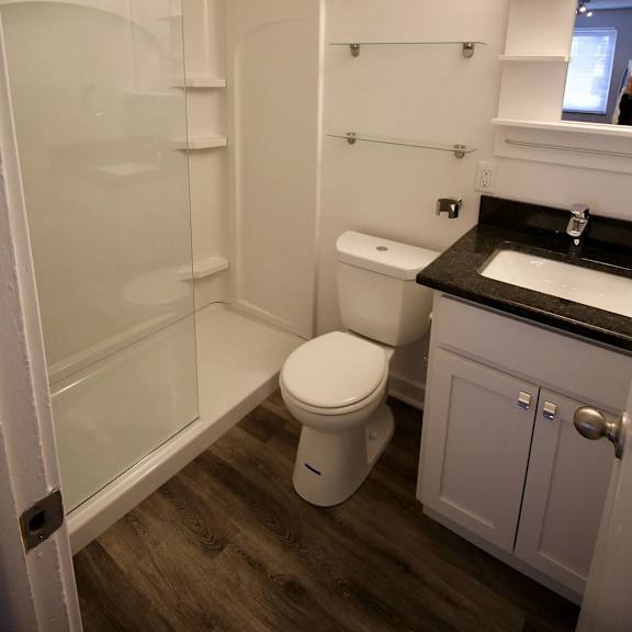 a white toilet sits in a bathroom next to a sink.