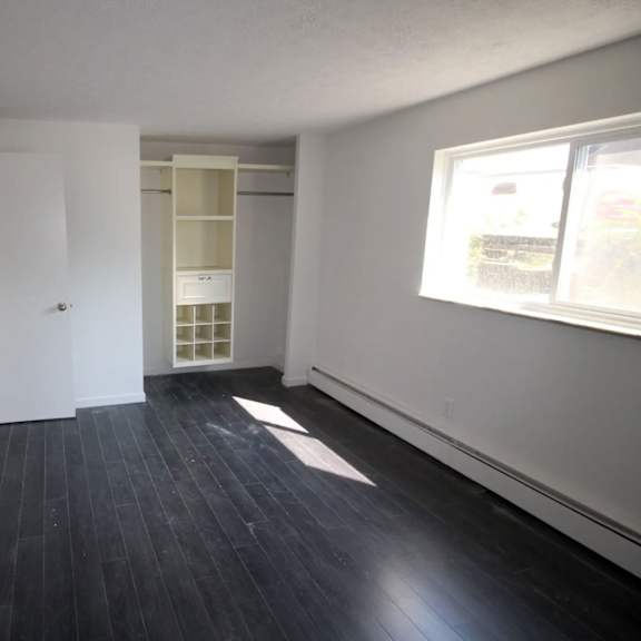 a room with a white door and a window with a white frame.