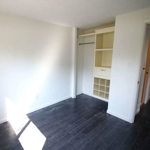 a room with a black floor and white walls.