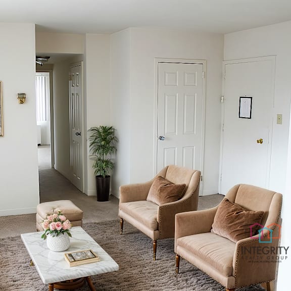 a living room with a white couch, two chairs, and a coffee table integrity realty, 44120