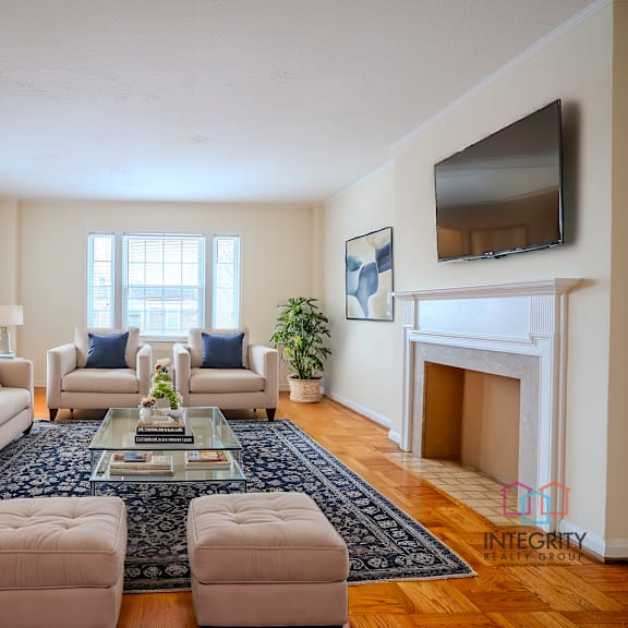 a living room with a fireplace and a tv mounted on the wall.at shaker collection, cleveland, 44120