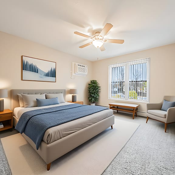 a bedroom with a large bed and a ceiling fan.