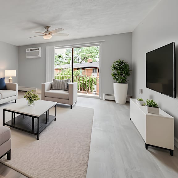 a living room with a grey couch, a white rug, and a ceiling fan. at integrity berea apartments, berea, ohio