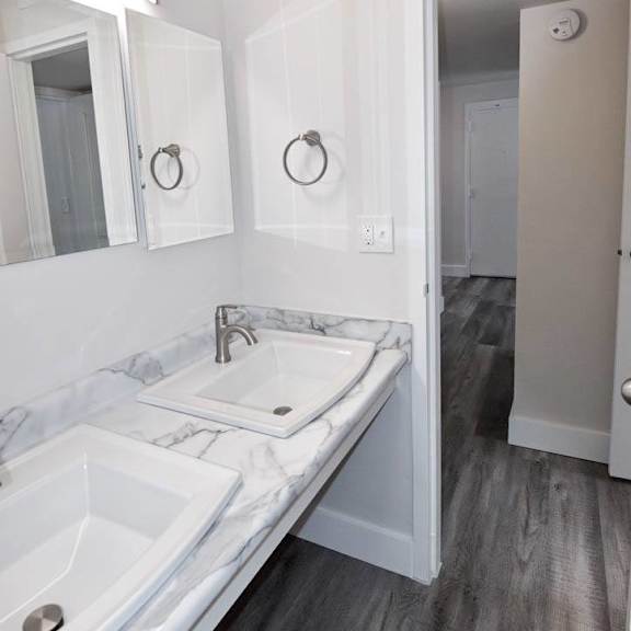 a renovated bathroom with two sinks at eagles landing apartments, integrity realty, kent