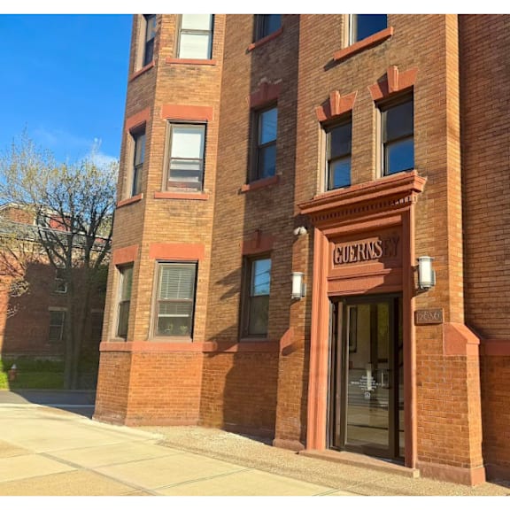 a red brick building with a glass door and windows.