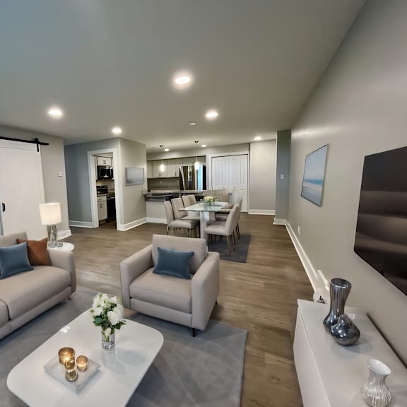 virtually staged living room with plank style flooring at old green place apartments, integrity realty llc, beachwood, oh