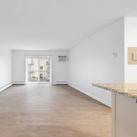 spacious living room with patio/balcony sliding door.