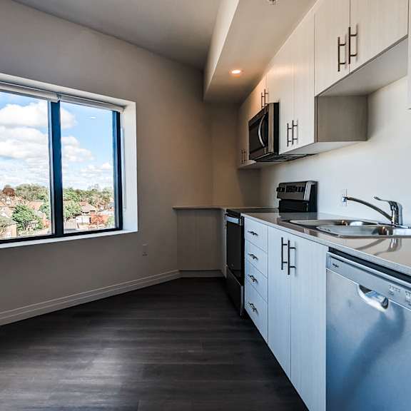 a kitchen with a view of the outdoors through the window.