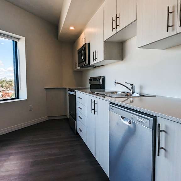 a kitchen with a washing machine and a microwave.