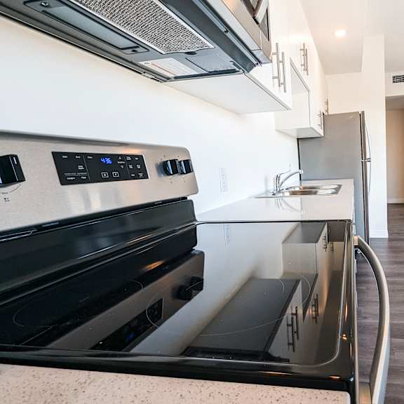 a modern kitchen with a black stove top oven.