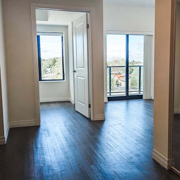 a room with wooden floors and white walls.
