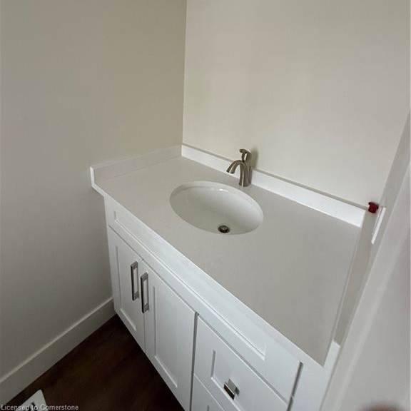 a white bathroom sink with a white cabinet below it.