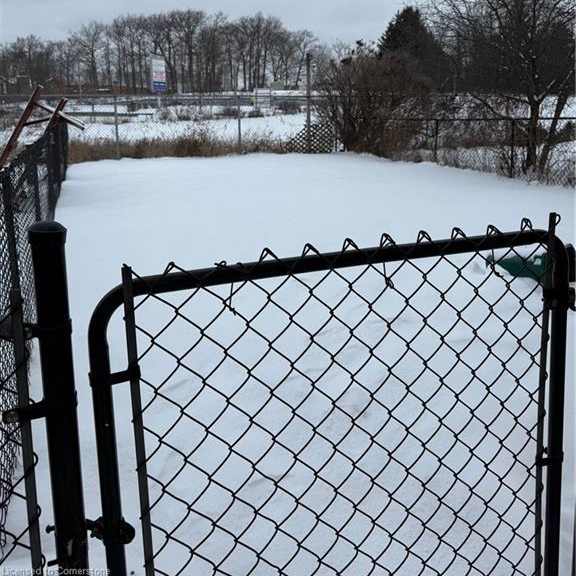 a gate blocks the entrance to a snowy field.