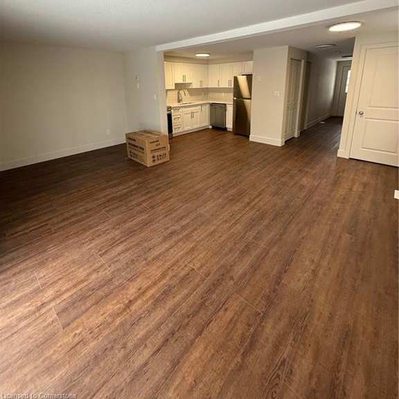 a room with wooden floors and a white ceiling.