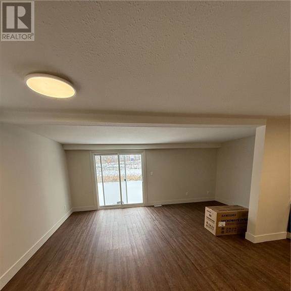 a room with wooden flooring and a window.