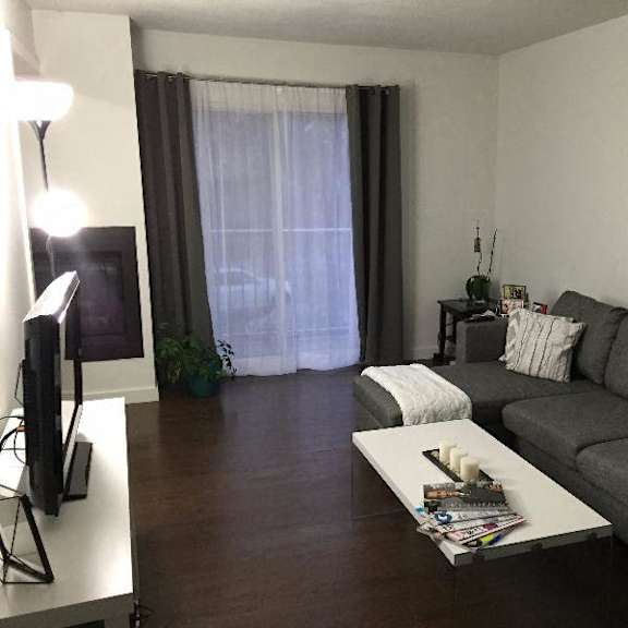 a living room with a grey couch and a coffee table.
