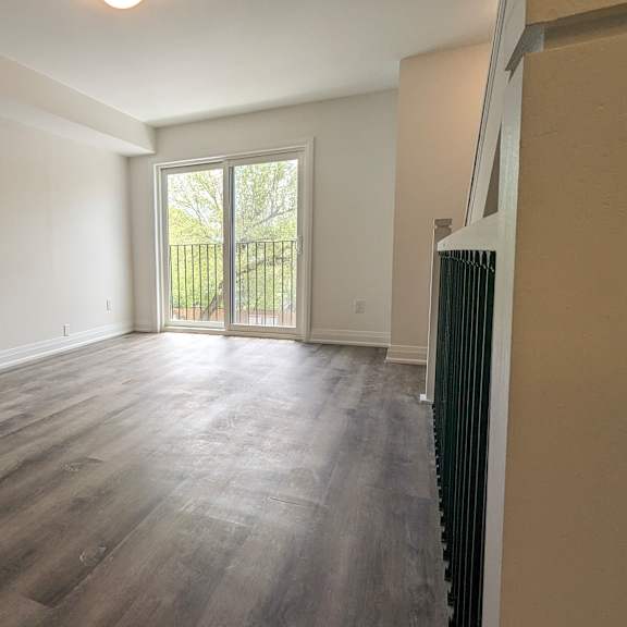 a room with wooden flooring and a window.