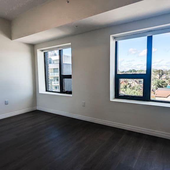 a room with a view of a residential area through the window.