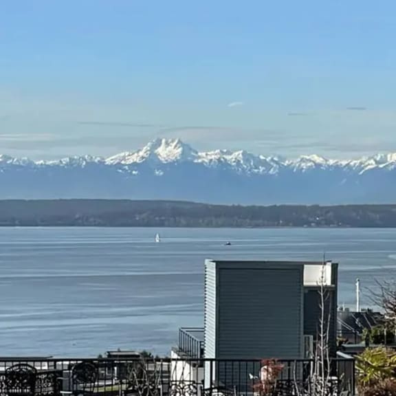 a large body of water with mountains in the background