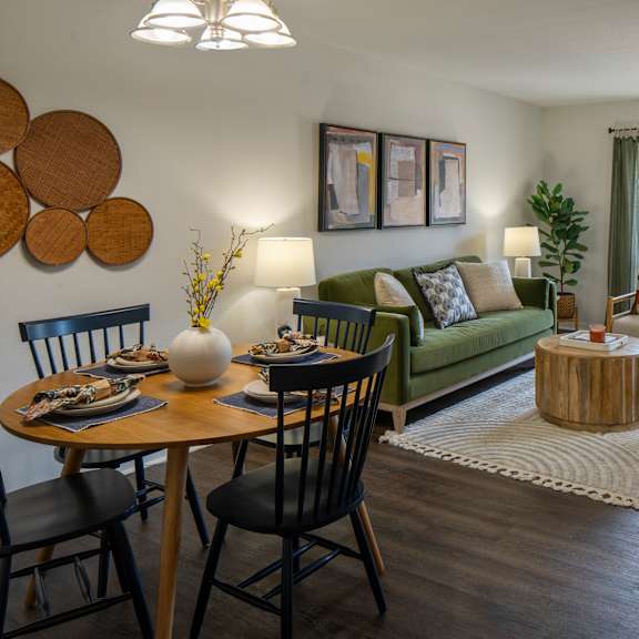 a living room with a dining table and chairs.