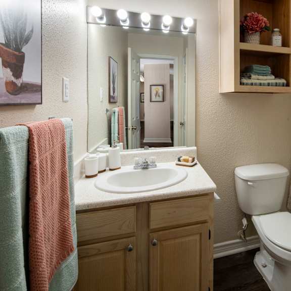 a bathroom with a toilet, sink, and shower curtain.