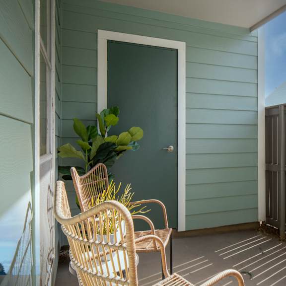 a patio with a chair and a table.