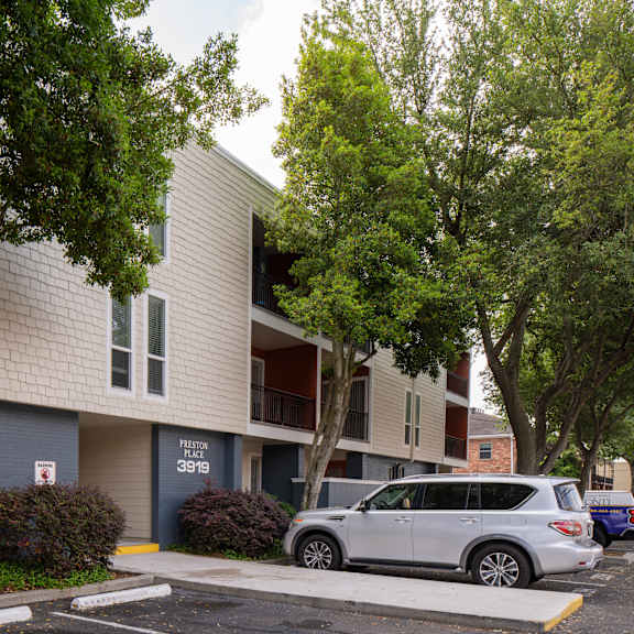 a silver car is parked in front of apartment number 3919.