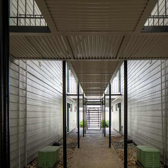 a long hallway with a light on the ceiling and a window on the wall.