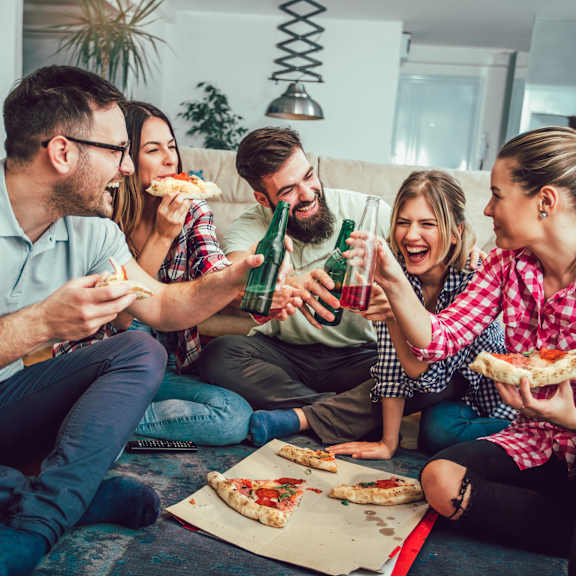 friends having pizza and drinks