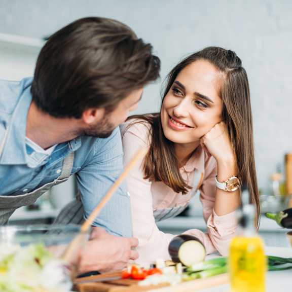 younger couple cooking together