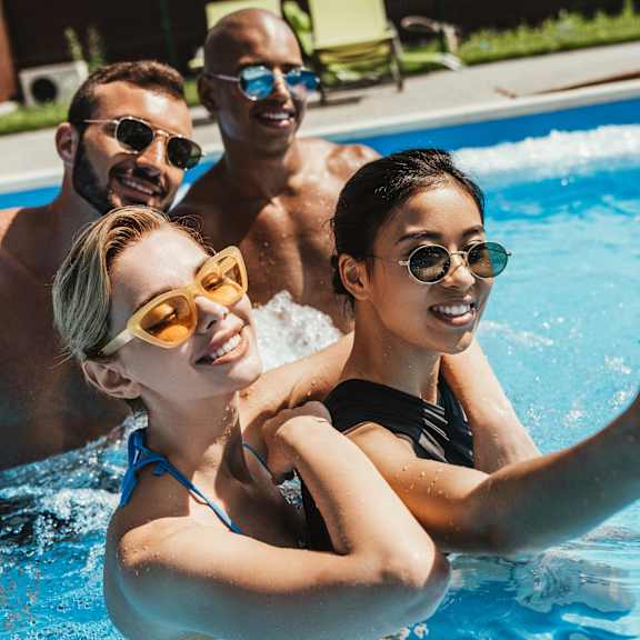 friends in a pool taking selfie