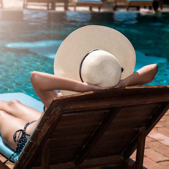 woman lounging by pool