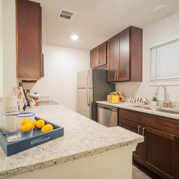 a kitchen with a large island with a tray of lemons on it