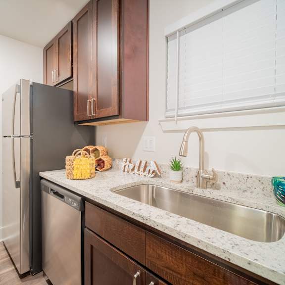 a kitchen with a sink and a refrigerator