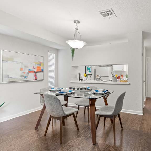 a dining room with a table set for four.