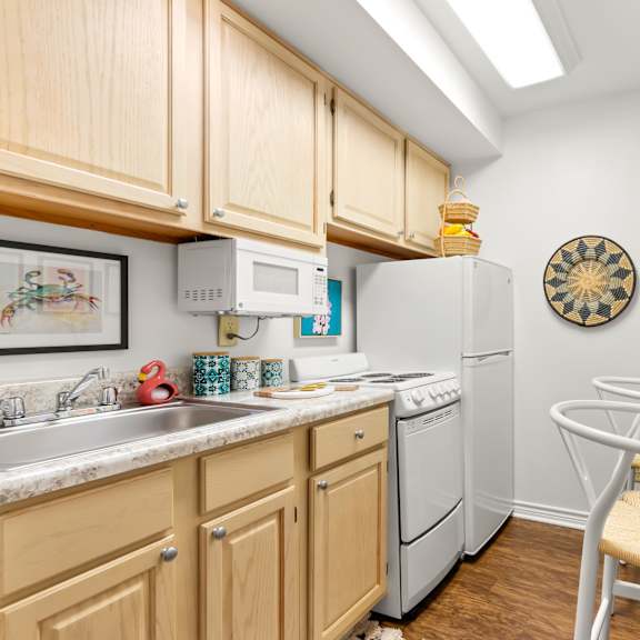 a kitchen with wooden cabinets and a white refrigerator.