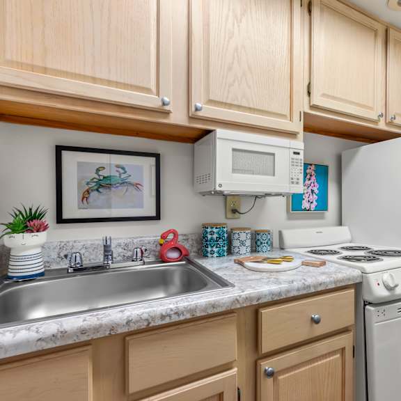 a kitchen with wooden cabinets and a white refrigerator.