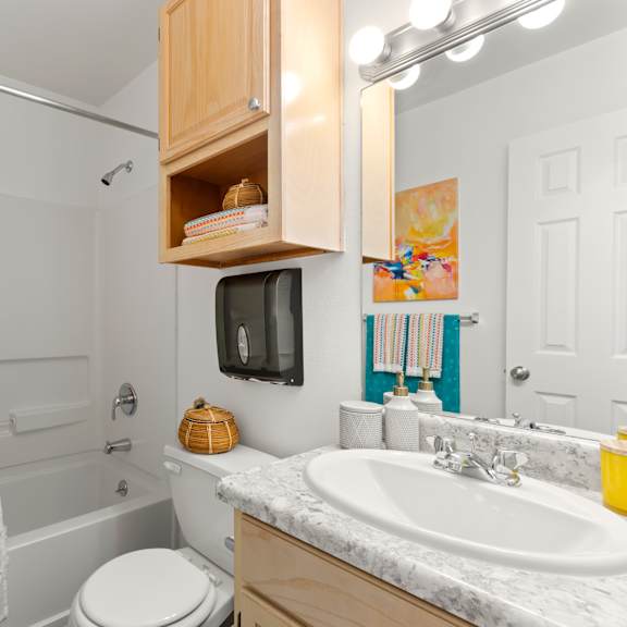 a bathroom with a white shower curtain and a white toilet.