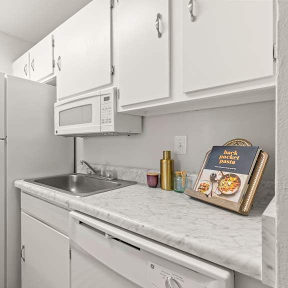 a kitchen with white appliances and cabinets.