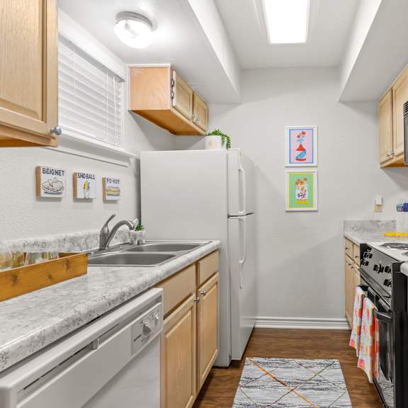 a kitchen with a white fridge and a black microwave.