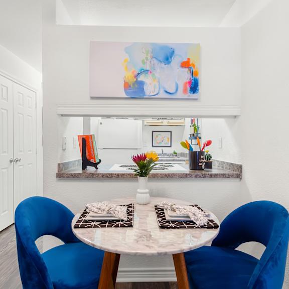 a dining room with a table and chairs.