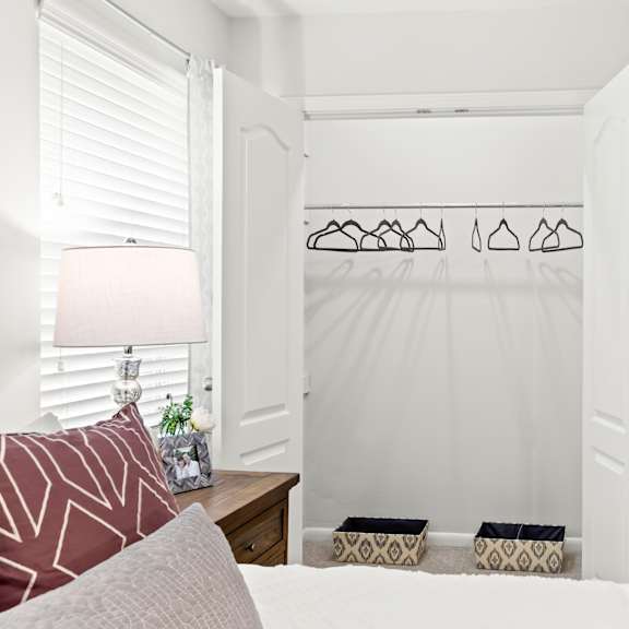a bedroom with a white bed and a white wall.