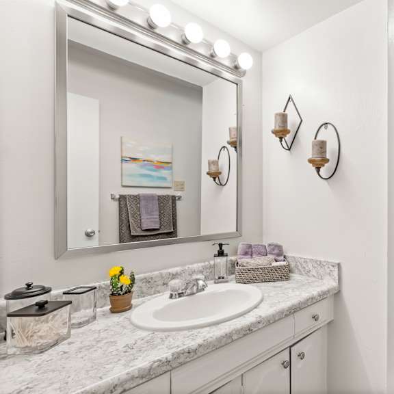 a bathroom with a white toilet and a white sink.
