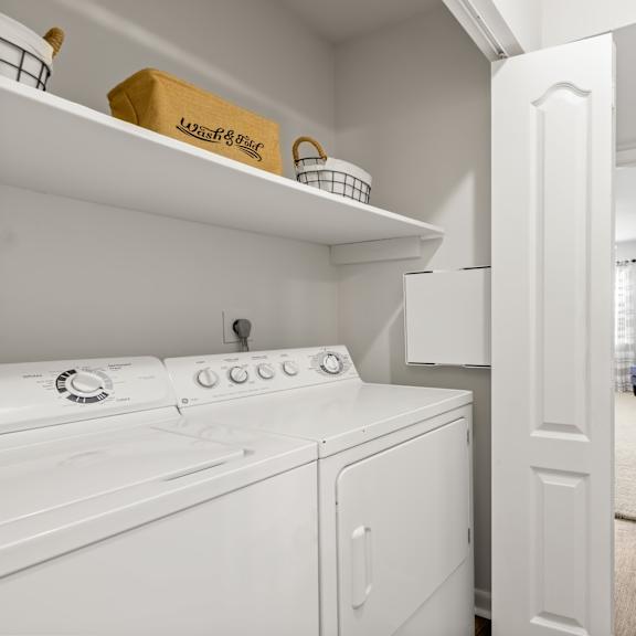 a white laundry room with a washer and dryer.