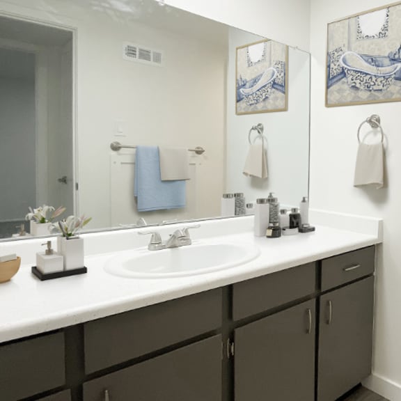 bathroom with two sinks and toilet