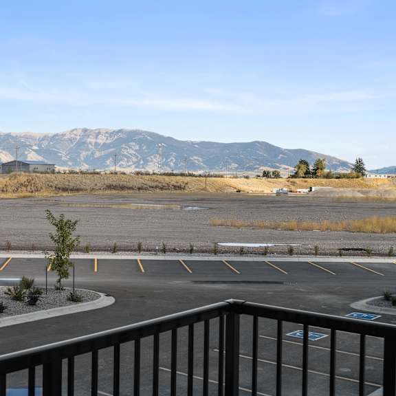 Thumbnail 21 of 21 View of the parking lot and mountains from the balcony at Yellowstone Landing, Belgrade, 59714