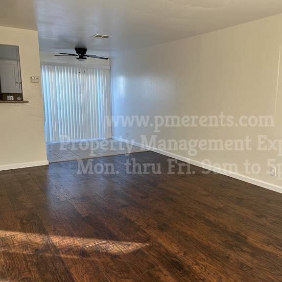 a room with a wooden floor and a ceiling fan.