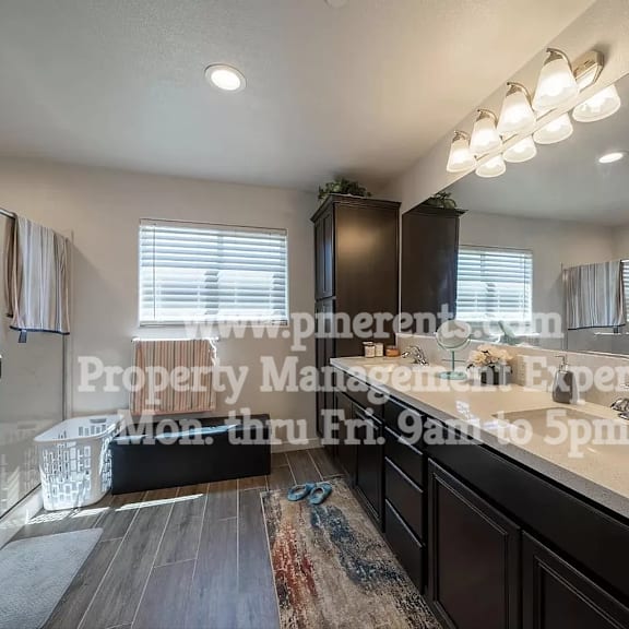 a bathroom with a large shower and a sink