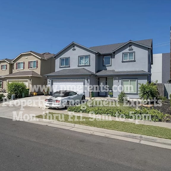 a row of houses on a street with a car parked in front