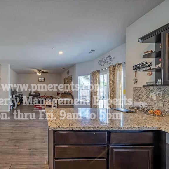 a kitchen with a counter top and a living room